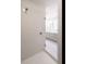 Bright shower with white tile and glass door leading to a modern bathroom at 201 Wash Hollow Dr, Wendell, NC 27591