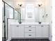 Bathroom with double vanity, black hardware, undermount sinks, decorative lighting, and a tiled shower at 220 Big Bradley Dr, Wendell, NC 27591