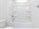 This bathroom features a sleek, modern tub-shower combo with built in shelving at 220 Big Bradley Dr, Wendell, NC 27591
