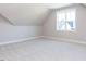 This neutral bedroom includes carpet, base molding and a window with an external view at 220 Big Bradley Dr, Wendell, NC 27591