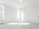 Sun-filled bedroom featuring plush carpet and two windows at 220 Big Bradley Dr, Wendell, NC 27591