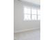 This unfurnished bedroom has neutral carpeting and a large window at 220 Big Bradley Dr, Wendell, NC 27591