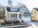 Charming gray home with a covered porch, white trim, and an attached two-car garage at 220 Big Bradley Dr, Wendell, NC 27591