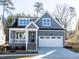 Charming gray home with a covered porch, white trim, and an attached two-car garage at 220 Big Bradley Dr, Wendell, NC 27591