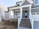 Close-up of the front porch with brick stairs, white railings, and a black front door at 220 Big Bradley Dr, Wendell, NC 27591
