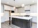 Modern kitchen with gray cabinets, stainless steel appliances, and a spacious island with pendant lighting at 220 Big Bradley Dr, Wendell, NC 27591