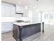 Open concept kitchen with a large center island, white cabinets, and stainless steel appliances at 220 Big Bradley Dr, Wendell, NC 27591