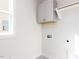 Laundry room has gray upper cabinets, natural light and updated electrical outlets at 220 Big Bradley Dr, Wendell, NC 27591