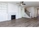 Cozy living room featuring built-in shelving, a fireplace, and hardwood floors at 220 Big Bradley Dr, Wendell, NC 27591