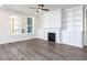 Bright living room with a fireplace, built-in shelving, and large windows at 220 Big Bradley Dr, Wendell, NC 27591