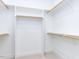 This walk-in closet has a standard configuration and includes built-in wooden closet rods at 220 Big Bradley Dr, Wendell, NC 27591