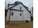 Rear view of the house showcasing the vinyl siding and window placement at 525 N Hoover Rd, Durham, NC 27703