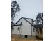 Side view of the house highlighting the vinyl siding, dormers, and porch at 525 N Hoover Rd, Durham, NC 27703