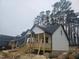 Newly constructed home with white vinyl siding, gray trim, and a covered porch at 525 N Hoover Rd, Durham, NC 27703