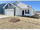 Newly built home with white and gray siding, a two-car garage, and a small front yard at 1050 Parkside Drive, Nashville, NC 27856