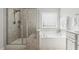 Bright bathroom with a glass enclosed shower and a soaking tub at 232 Big Barn Dr, Wendell, NC 27591