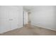 Neutral bedroom featuring carpet, double door closet, and an open doorway at 232 Big Barn Dr, Wendell, NC 27591