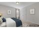 Virtually staged bedroom with neutral walls, carpet, framed art, and a window at 232 Big Barn Dr, Wendell, NC 27591
