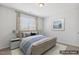 Cozy staged bedroom with decor and large windows for natural lighting at 232 Big Barn Dr, Wendell, NC 27591