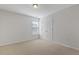 Neutral bedroom featuring carpet, double door closet, and a window at 232 Big Barn Dr, Wendell, NC 27591