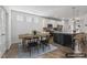 Staged dining room view into kitchen showcasing an island with modern appliances at 232 Big Barn Dr, Wendell, NC 27591