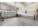 Unfinished garage featuring concrete floors, cinder block foundation walls, and a metal garage door at 232 Big Barn Dr, Wendell, NC 27591