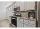This charming kitchen features modern appliances, stylish countertops and white cabinetry at 232 Big Barn Dr, Wendell, NC 27591