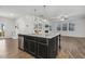 Stylish kitchen island features storage, seating, and an open view to the living area at 232 Big Barn Dr, Wendell, NC 27591