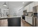 Modern kitchen with stainless appliances, stone countertops, and spacious island with pendant lighting at 232 Big Barn Dr, Wendell, NC 27591