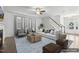 Staged living room with stylish furnishings and a view of the entryway and staircase at 232 Big Barn Dr, Wendell, NC 27591