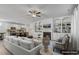 Staged living area with fireplace, built-in shelving, and open flow to the kitchen featuring modern appliances at 232 Big Barn Dr, Wendell, NC 27591