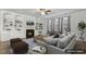 Staged living room with built-in shelving, fireplace, and comfortable seating arrangement on a stylish rug at 232 Big Barn Dr, Wendell, NC 27591