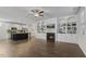 Bright, open-concept layout with fireplace, shelving, and seamless transition to the modern kitchen area at 232 Big Barn Dr, Wendell, NC 27591