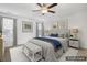 Staged main bedroom with ceiling fan, neutral decor, and carpet flooring at 232 Big Barn Dr, Wendell, NC 27591
