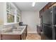 Simple kitchen with dark brown cabinets, stainless steel sink and black appliances at 4505 Laymans Chapel Rd, Durham, NC 27704