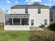 Home's back exterior view showcasing the screened porch and backyard at 821 Stackhurst Way, Wake Forest, NC 27587
