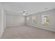 Spacious bedroom featuring neutral walls, carpet flooring, a ceiling fan and three windows with lovely natural light at 821 Stackhurst Way, Wake Forest, NC 27587