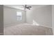 A cozy bedroom features neutral colored walls, carpet flooring, and a window bringing in soft natural light at 821 Stackhurst Way, Wake Forest, NC 27587