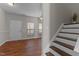 View of the front door and stairs, showcasing the wood floors and neutral wall paint at 821 Stackhurst Way, Wake Forest, NC 27587