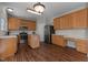 Eat-in kitchen with wood cabinets, center island, and stainless steel appliances at 821 Stackhurst Way, Wake Forest, NC 27587