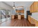 Open kitchen featuring wood cabinets, stainless steel appliances, island, and access to the deck at 821 Stackhurst Way, Wake Forest, NC 27587