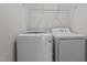 Bright laundry area featuring modern appliances and convenient overhead shelving at 821 Stackhurst Way, Wake Forest, NC 27587