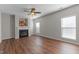 Spacious living room features a cozy fireplace, wood floors, and natural light through windows at 821 Stackhurst Way, Wake Forest, NC 27587