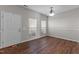 Inviting living room featuring wood floors, white walls, natural light, and front door at 821 Stackhurst Way, Wake Forest, NC 27587