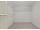 A walk-in closet with carpet flooring, shelves, and rack spaces for clothing at 821 Stackhurst Way, Wake Forest, NC 27587