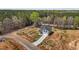 New home on a large lot with a long concrete driveway, surrounded by mature trees at 9184 Phoenix Ct, Middlesex, NC 27557