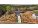 An aerial view of a two-story home reveals its full yard and surrounding woods at 9184 Phoenix Ct, Middlesex, NC 27557