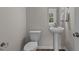 Half bath featuring a pedestal sink, sleek fixtures, and neutral decor at 9184 Phoenix Ct, Middlesex, NC 27557