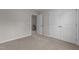 Bedroom featuring neutral walls, plush carpet, an open doorway, and a double doored closet at 9184 Phoenix Ct, Middlesex, NC 27557