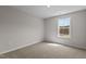 A cozy bedroom with a large window and neutral walls with plush carpeting at 9184 Phoenix Ct, Middlesex, NC 27557